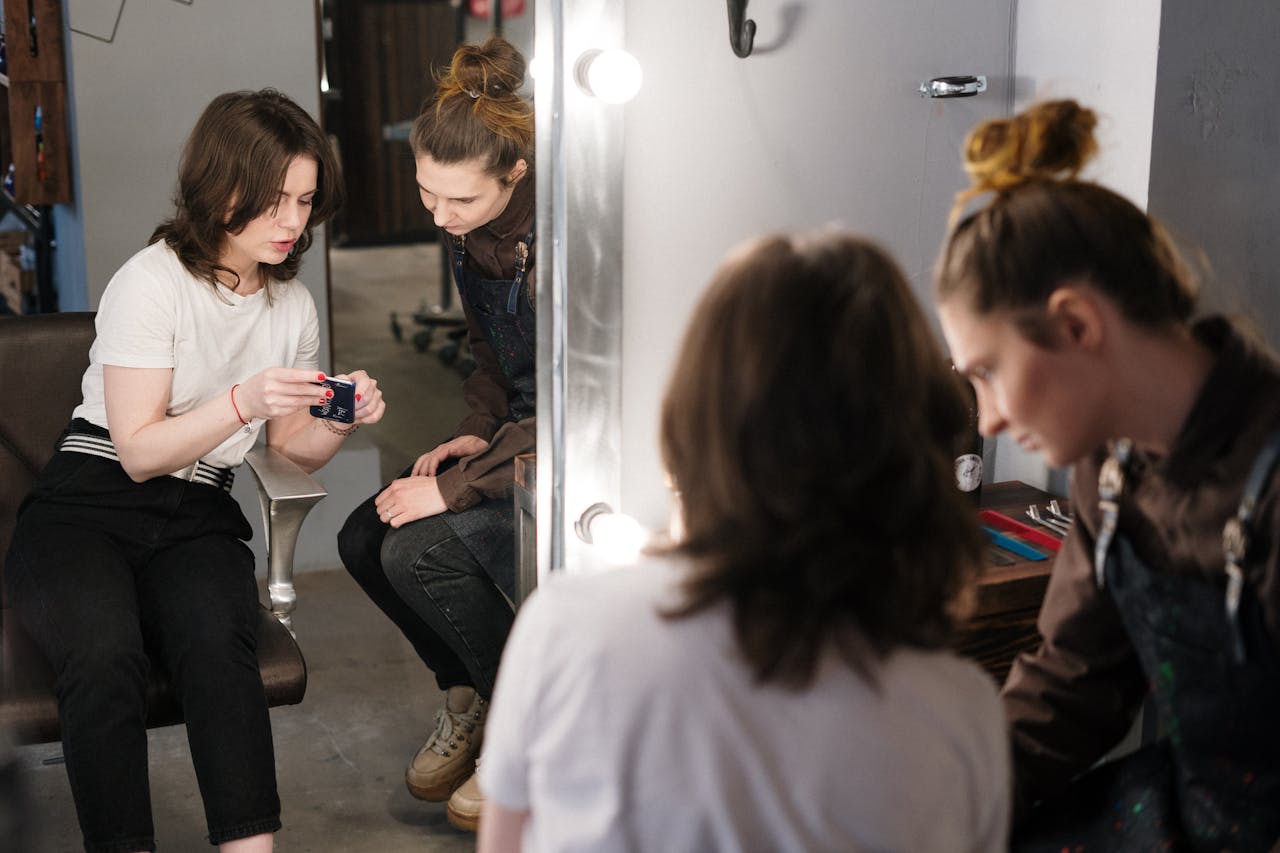 Two women engaged in a hair consultation at a salon, reflecting professionalism and style.